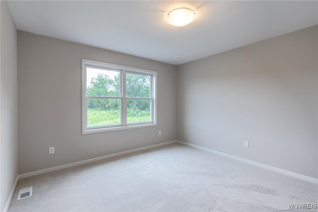 unfurnished room with light carpet