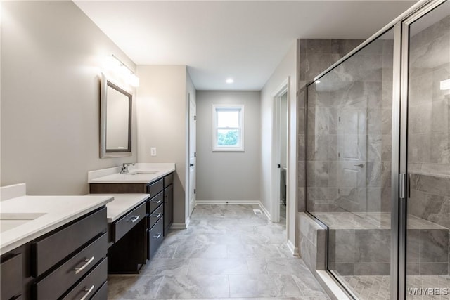 bathroom featuring vanity and a shower with door