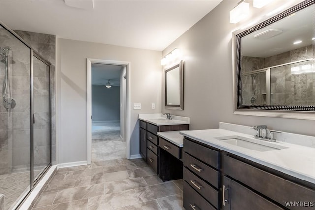 bathroom featuring ceiling fan, vanity, and a shower with shower door