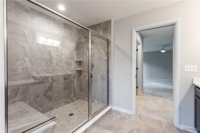 bathroom with vanity, ceiling fan, and walk in shower