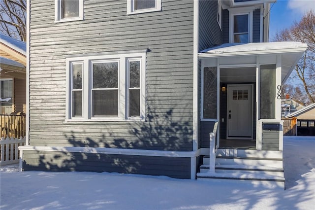 view of snow covered property entrance