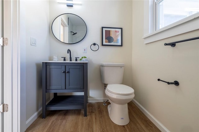 bathroom featuring vanity, hardwood / wood-style floors, and toilet