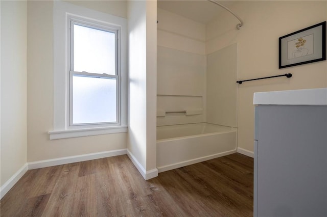 bathroom with shower / bath combination and wood-type flooring