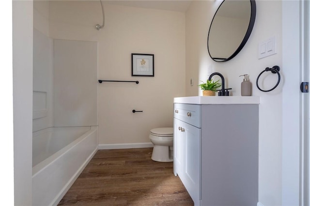 full bathroom with vanity, hardwood / wood-style flooring,  shower combination, and toilet