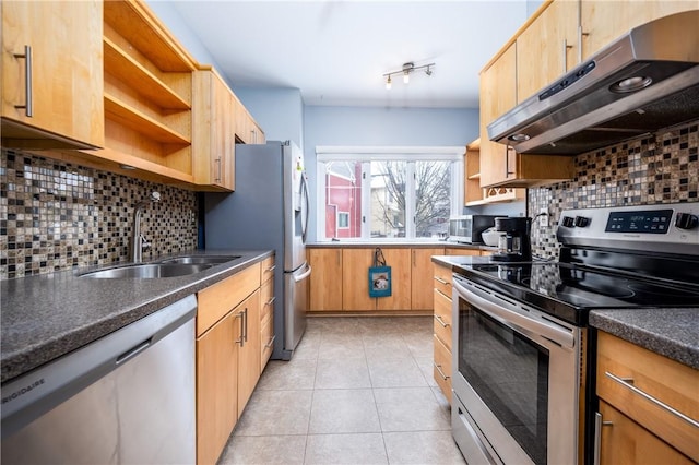 kitchen featuring tasteful backsplash, stainless steel appliances, sink, and light tile patterned floors