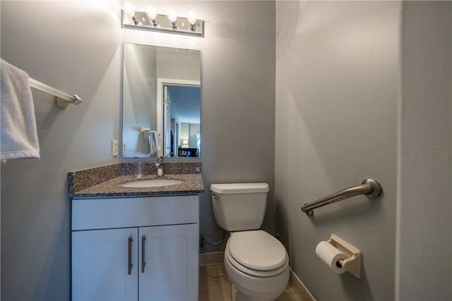 bathroom with vanity, tile patterned floors, and toilet