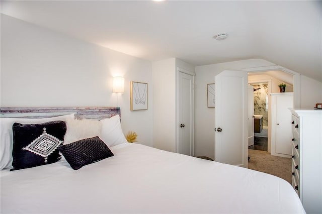 bedroom featuring lofted ceiling and carpet floors