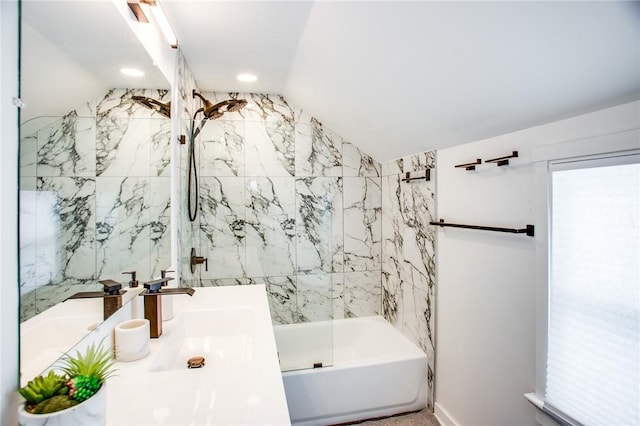 bathroom with lofted ceiling, tiled shower / bath combo, and vanity