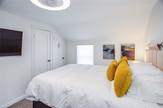 bedroom featuring lofted ceiling, radiator heating unit, and carpet