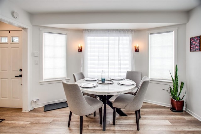 dining area featuring light hardwood / wood-style floors and a wealth of natural light