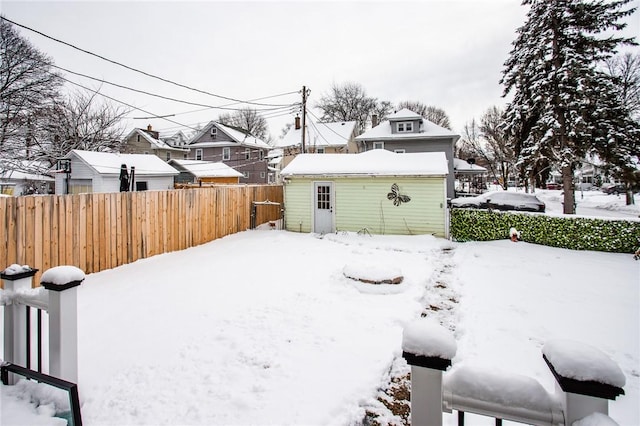 yard covered in snow with an outdoor structure