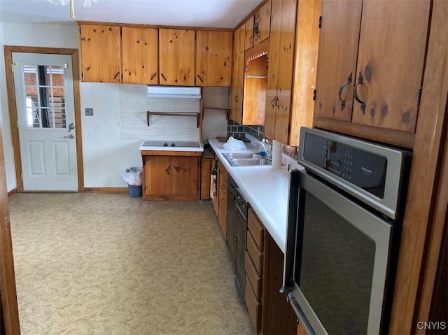 kitchen with tasteful backsplash, sink, oven, and black dishwasher