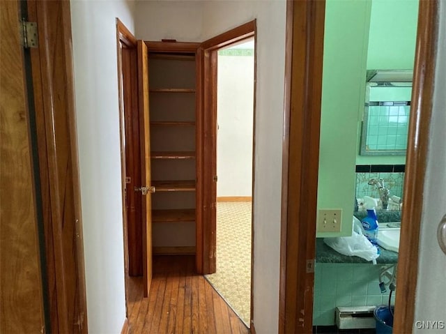 hallway with hardwood / wood-style floors