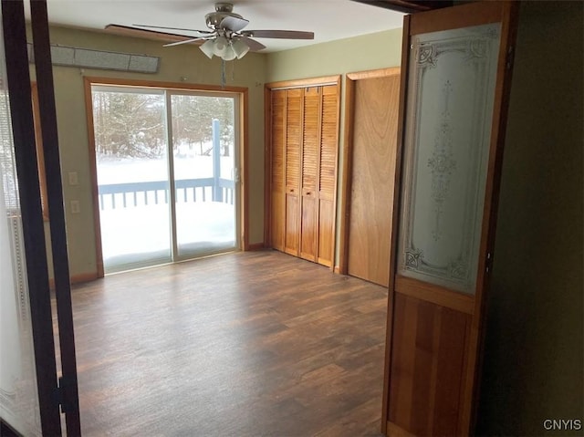 spare room with ceiling fan and dark hardwood / wood-style flooring