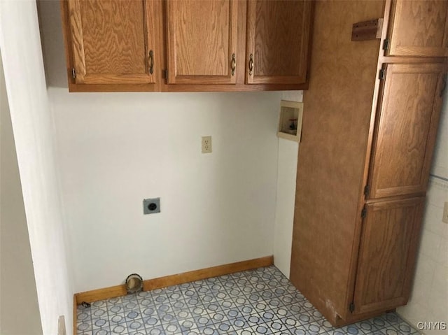 laundry room with electric dryer hookup, hookup for a washing machine, and cabinets