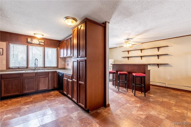 kitchen featuring dishwasher, sink, a textured ceiling, and ceiling fan