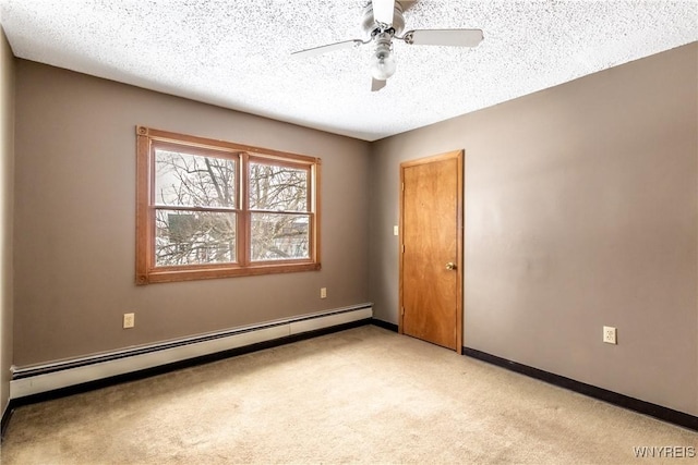 spare room featuring ceiling fan, a baseboard radiator, light carpet, and a textured ceiling