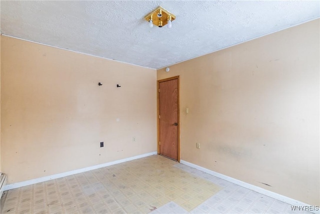 unfurnished room featuring a textured ceiling