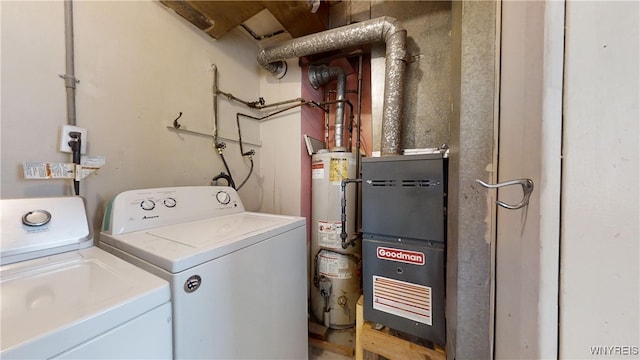 laundry area with washing machine and dryer and water heater