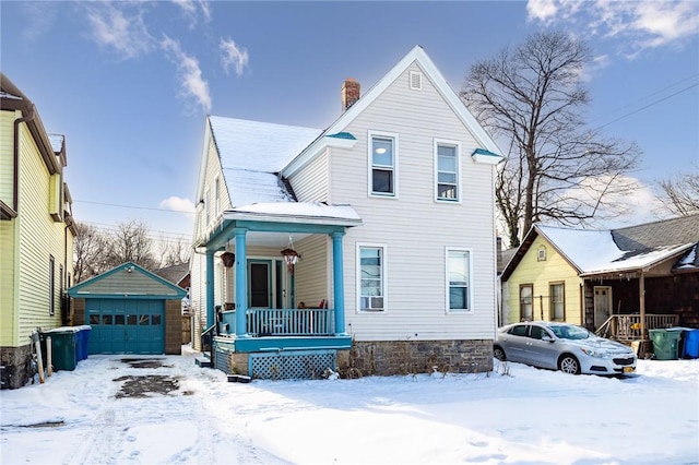 view of front of home with a porch, a garage, and an outdoor structure