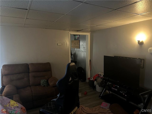 living room featuring a drop ceiling and wood-type flooring