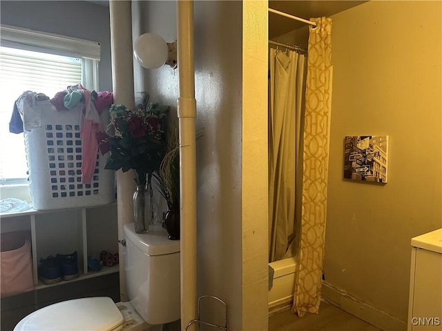 bathroom with shower / bath combo with shower curtain and toilet