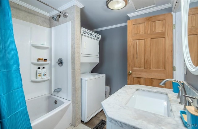 bathroom with stacked washer and clothes dryer, crown molding, vanity, and shower / bathtub combination with curtain