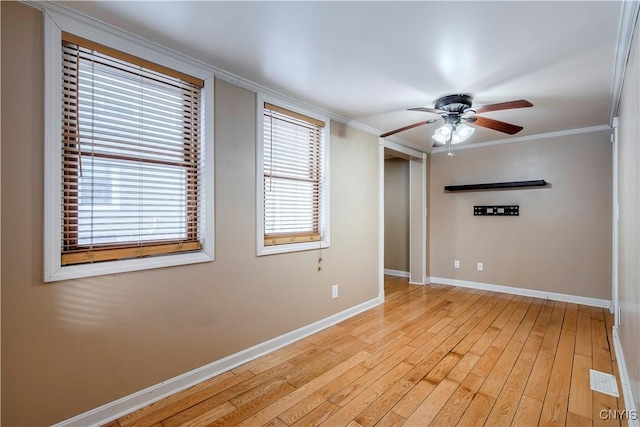 unfurnished room with light hardwood / wood-style flooring, crown molding, and ceiling fan