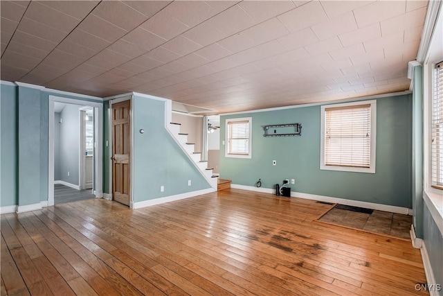 basement with ornamental molding and hardwood / wood-style flooring