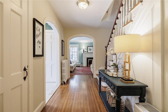 corridor with hardwood / wood-style flooring