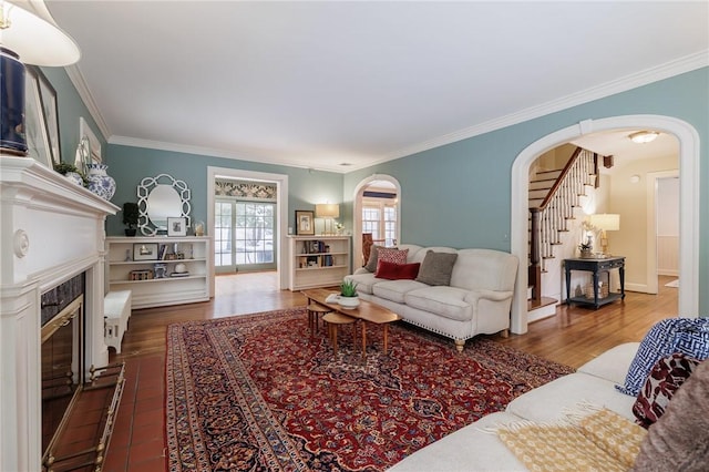 living room with ornamental molding and wood-type flooring