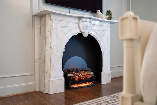 details with hardwood / wood-style flooring and a premium fireplace