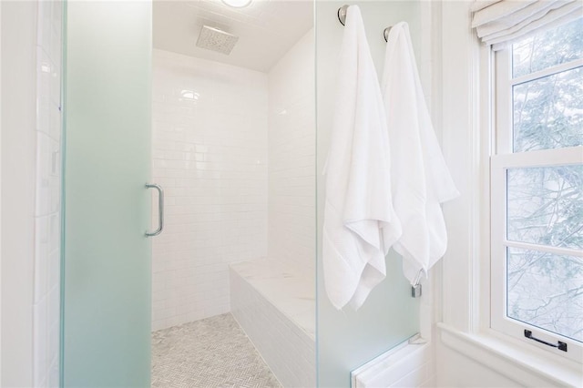 bathroom with a shower with shower door