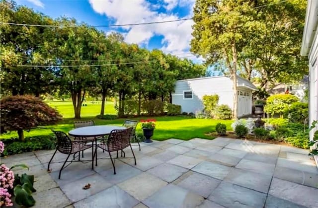 view of patio with an outbuilding