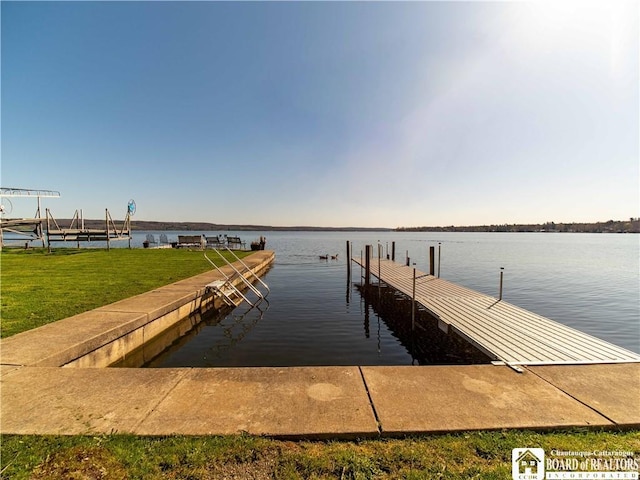 dock area featuring a water view and a lawn