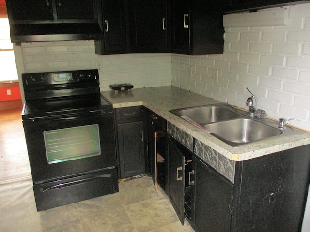 kitchen featuring backsplash, range hood, sink, and electric range