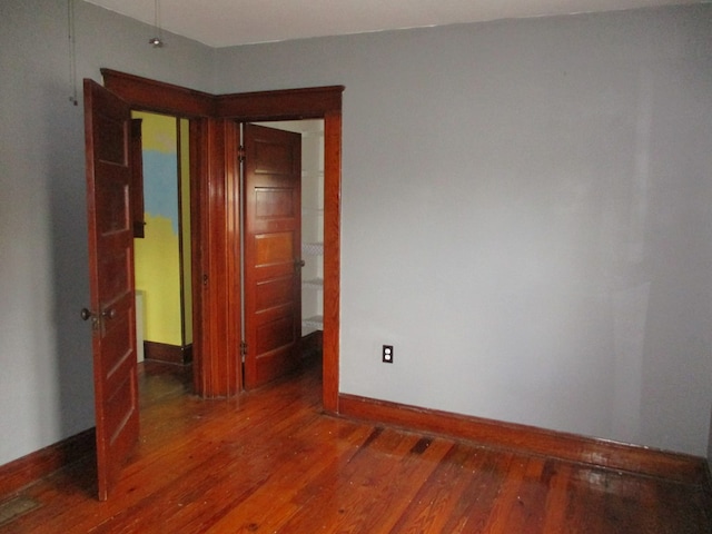 empty room featuring dark wood-type flooring