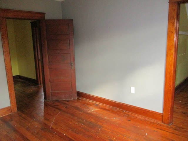 unfurnished room featuring dark wood-type flooring