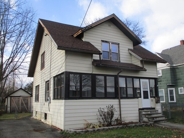 view of front of home featuring a shed