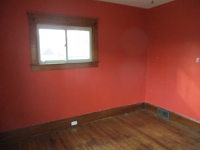 empty room with hardwood / wood-style floors