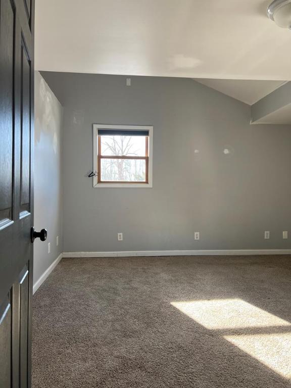 576 W High St, Erwin, NY 14870 - carpeted spare room featuring lofted ceiling and baseboards
