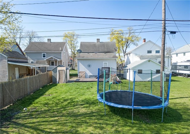 576 W High St, Erwin, NY 14870 - view of yard with a trampoline, an outdoor structure, a storage shed, a deck, and fence