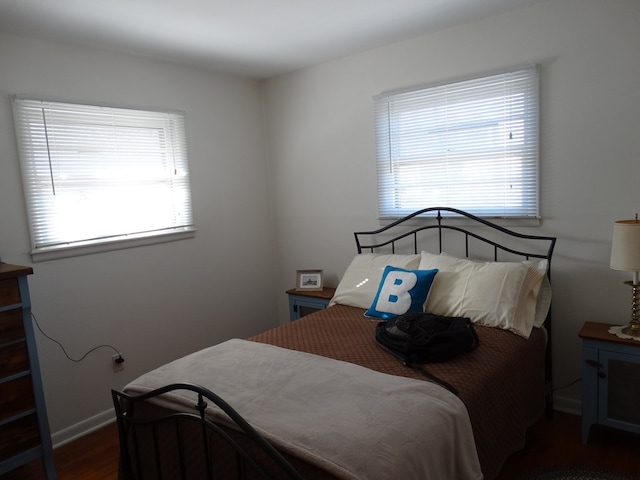 bedroom with dark hardwood / wood-style flooring