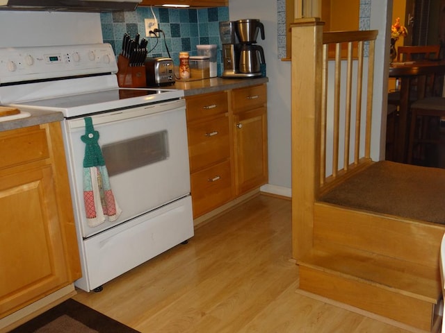 kitchen with tasteful backsplash, white electric range oven, extractor fan, and light hardwood / wood-style floors