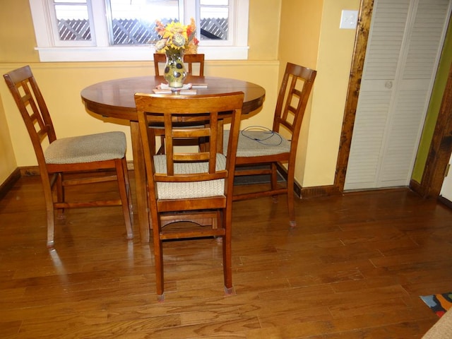 dining room with dark hardwood / wood-style flooring