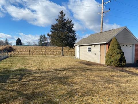 view of yard featuring a garage and an outdoor structure