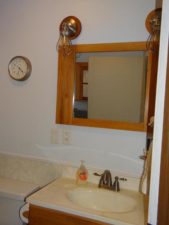 bathroom featuring vanity and toilet