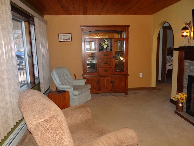 living room with a baseboard radiator, light colored carpet, wooden ceiling, and a fireplace