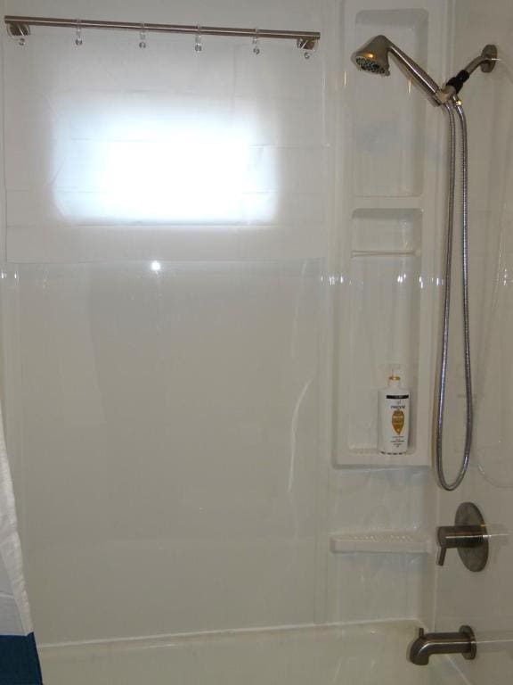 bathroom featuring shower / bath combo with shower curtain