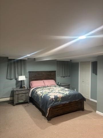 bedroom featuring a baseboard heating unit and carpet floors